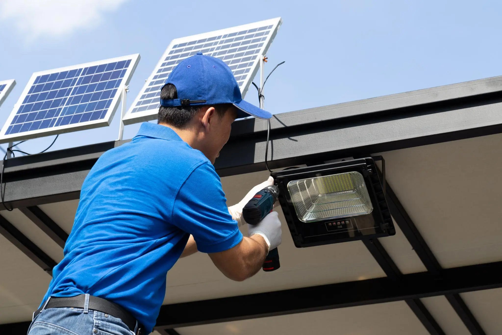 a worker is installing solar lights
