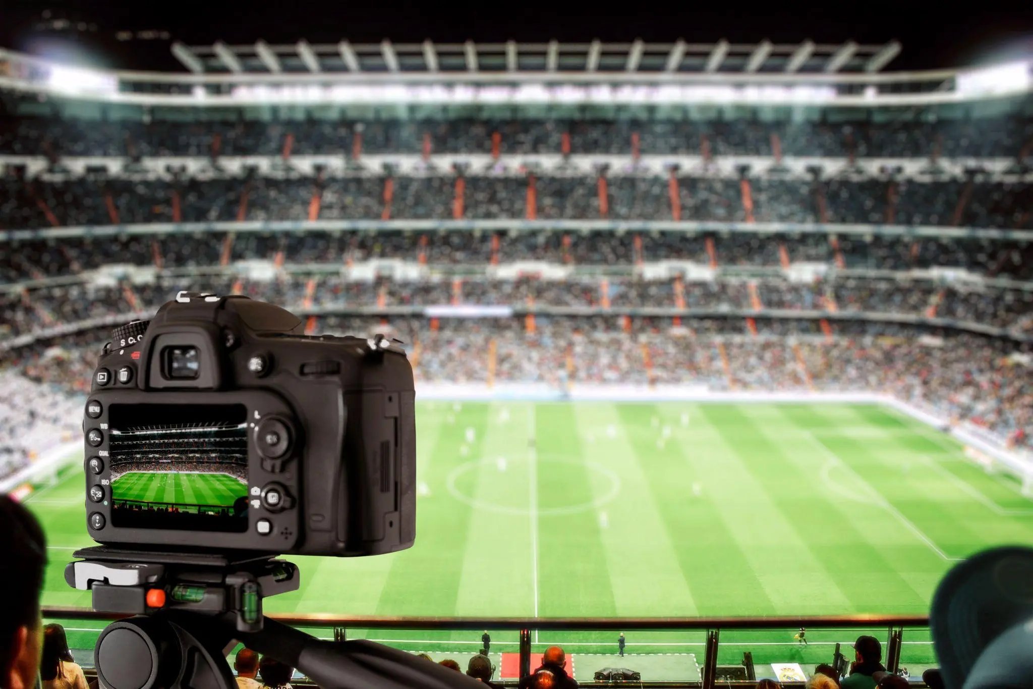 A DSLR camera is filming a football match