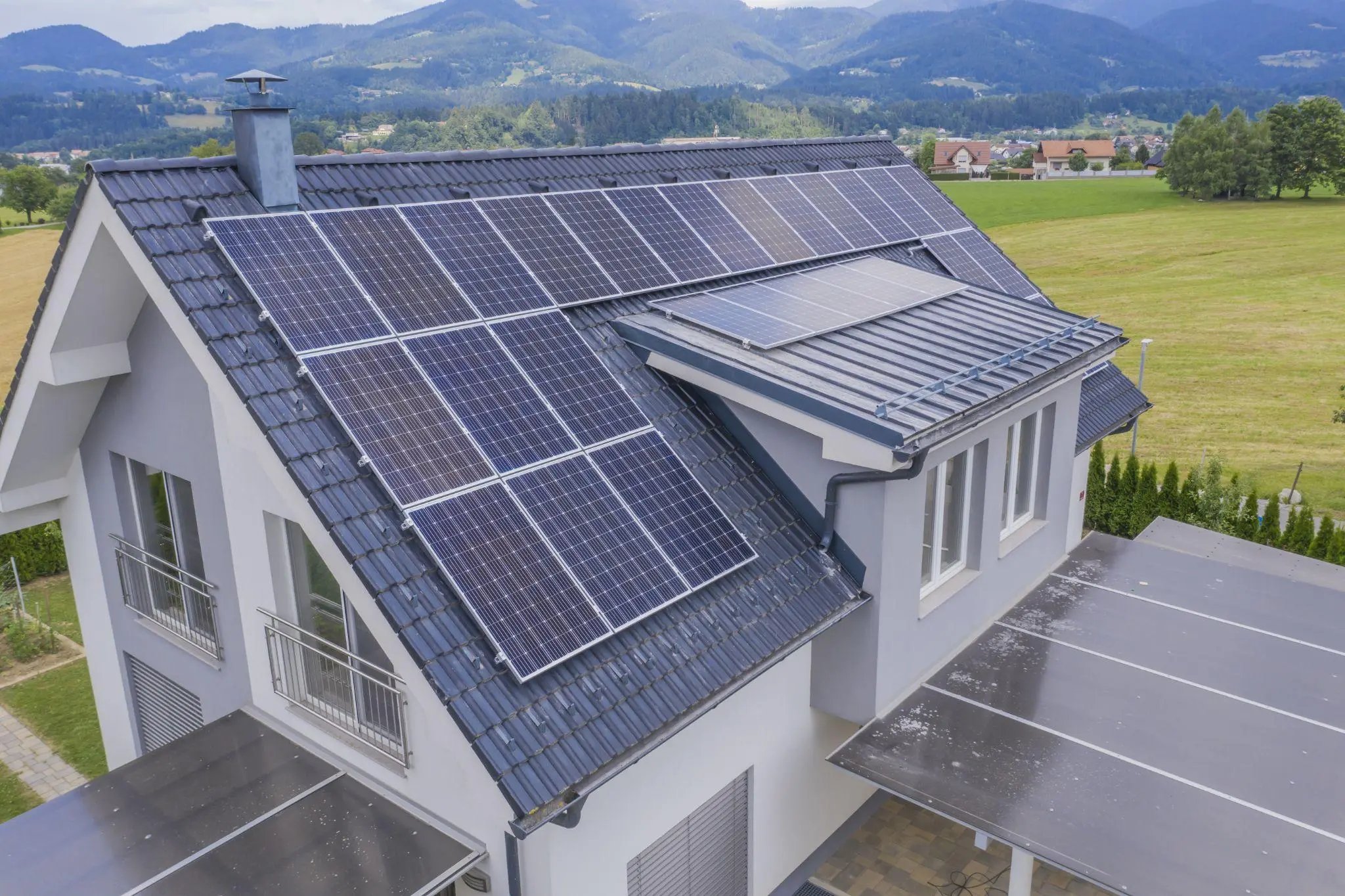aerial view of a private house with solar panels on the roof